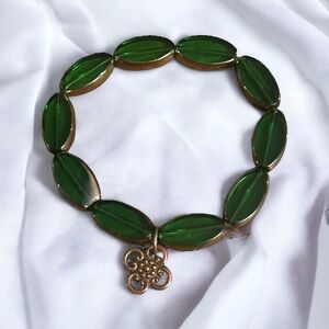 Green bezeled glass bead Celtic charm stretch bracelet